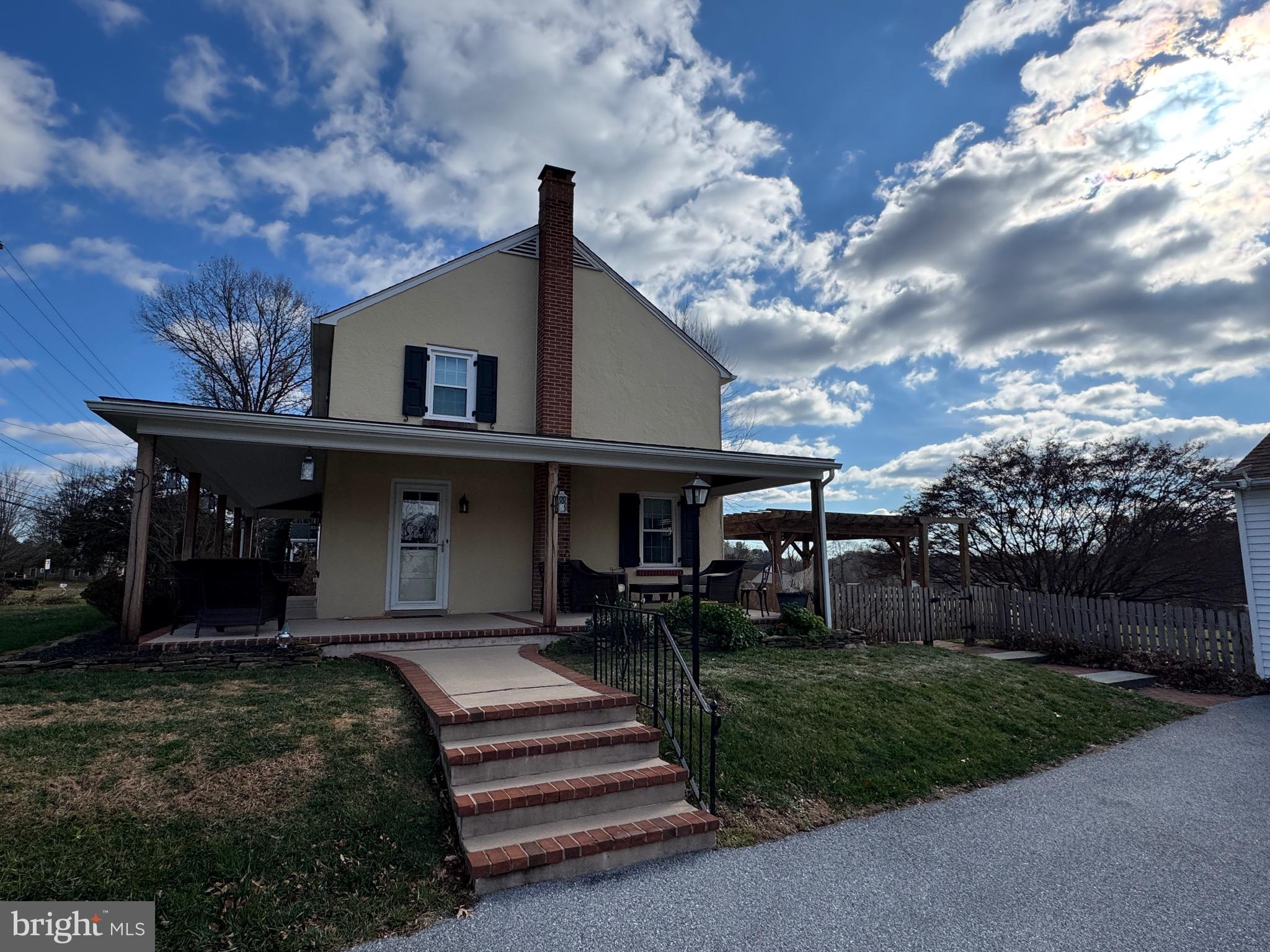 1776 West Doe Run Road Kennett Square, PA 19348 - Photo 8 of 34 a front view of a house with a garden and trees