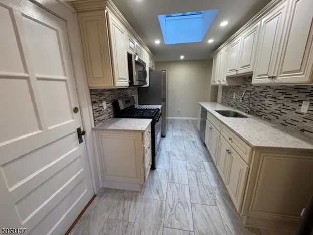 a kitchen with white cabinets and appliances