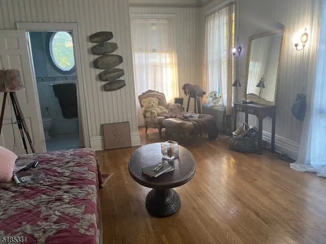 a living room with fireplace furniture and a wooden floor