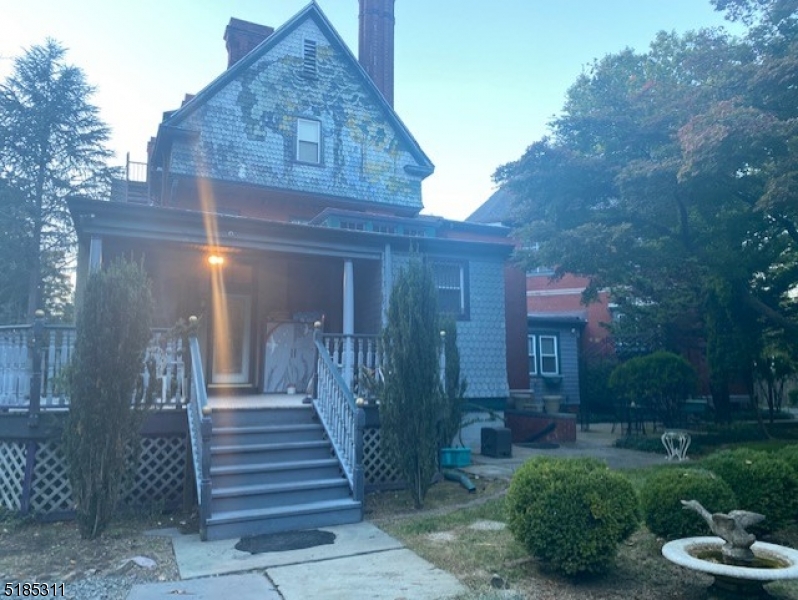 527 West 8th Street, Unit B Plainfield, NJ 07060 - Photo 28 of 30 a view of a brick house with a yard and plants
