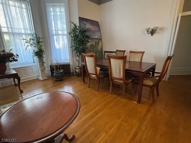 a view of a dining room with furniture and a potted plant