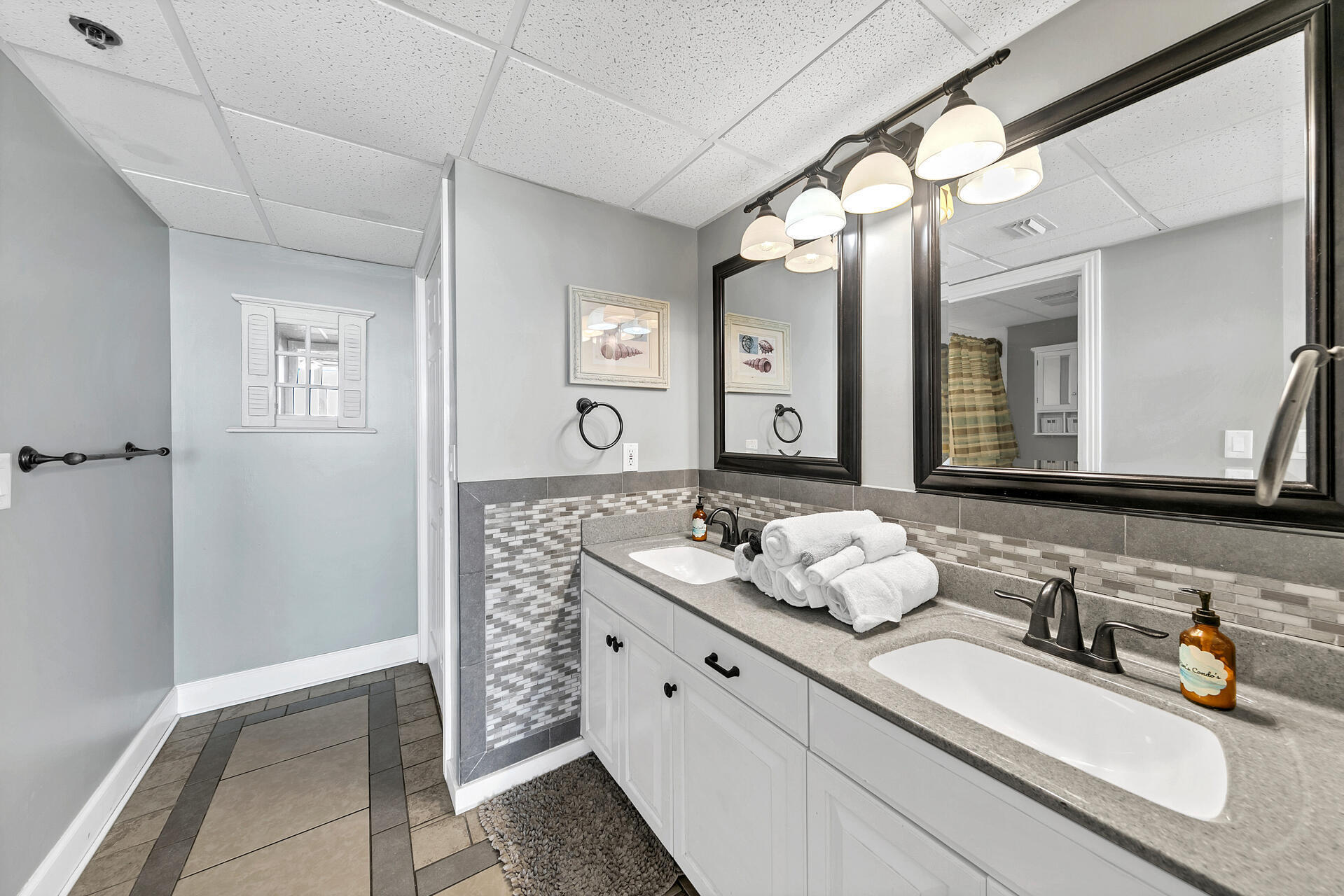 10515 Front Beach Road, Unit 102 Panama City Beach, FL 32407 - Photo 12 of 19 a bathroom with a sink and a mirror