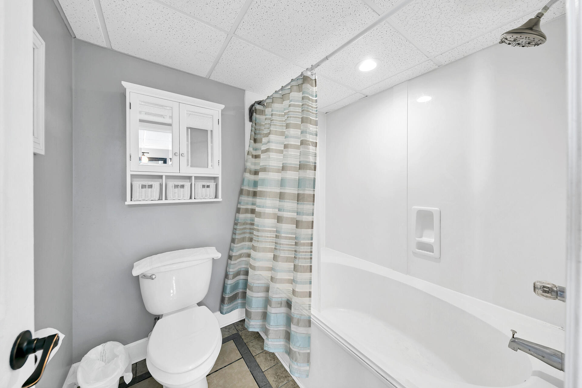 10515 Front Beach Road, Unit 102 Panama City Beach, FL 32407 - Photo 13 of 19 a white toilet sitting next to a bath tub