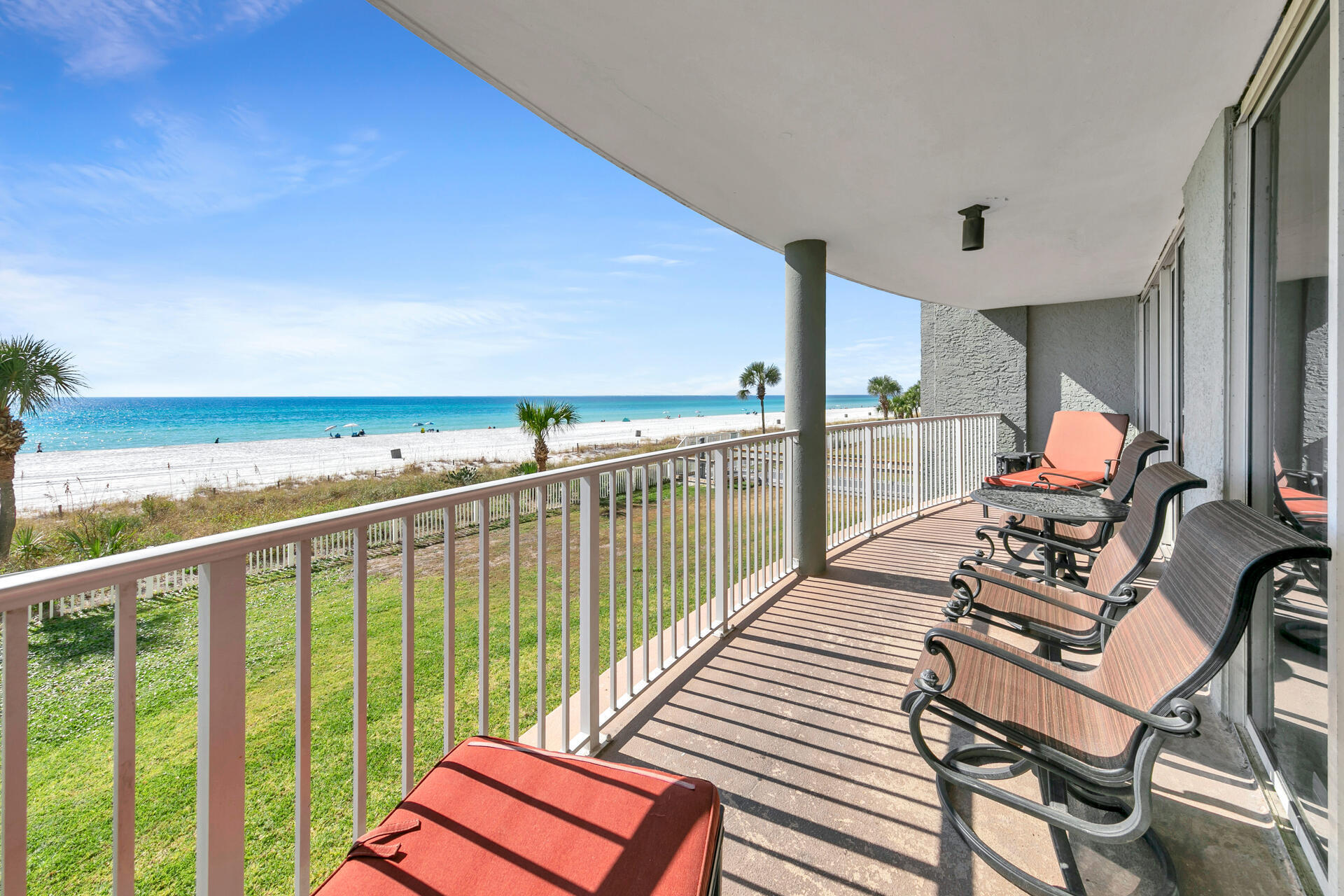 10515 Front Beach Road, Unit 102 Panama City Beach, FL 32407 - Photo 15 of 19 a view of a chairs and table in patio with wooden floor