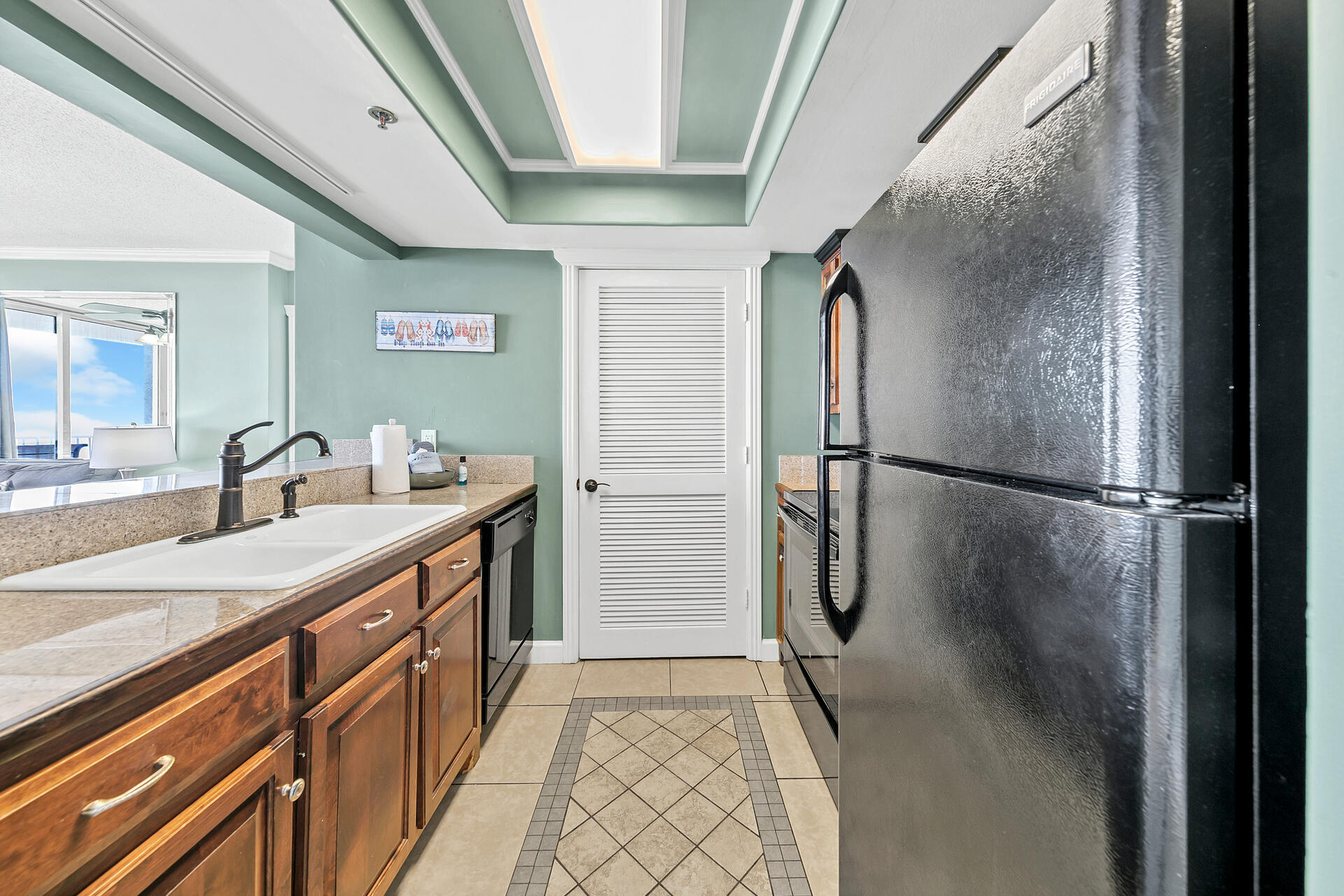 10515 Front Beach Road, Unit 102 Panama City Beach, FL 32407 - Photo 3 of 19 a bathroom with a sink and mirror