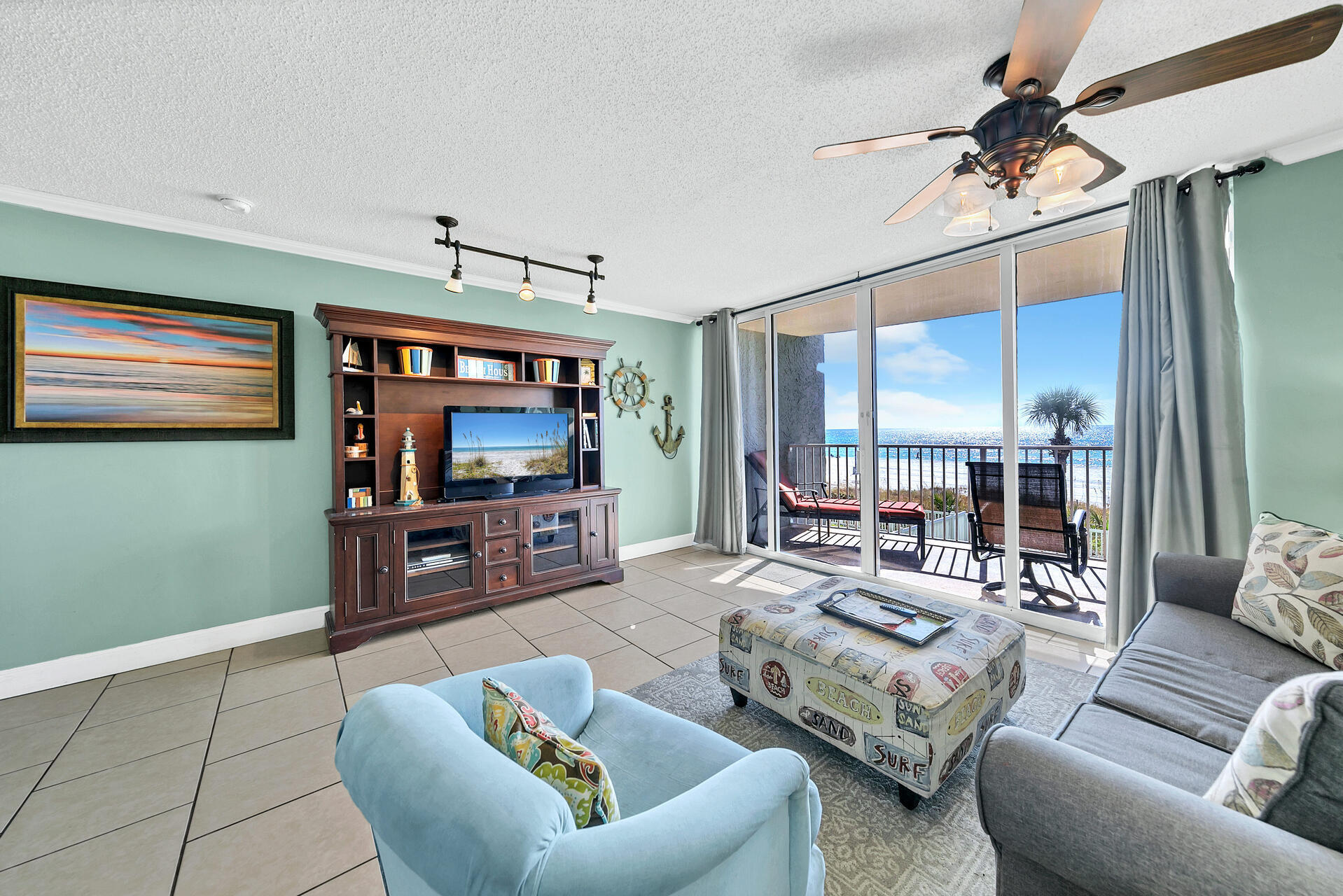 10515 Front Beach Road, Unit 102 Panama City Beach, FL 32407 - Photo 6 of 19 a living room with furniture and a flat screen tv