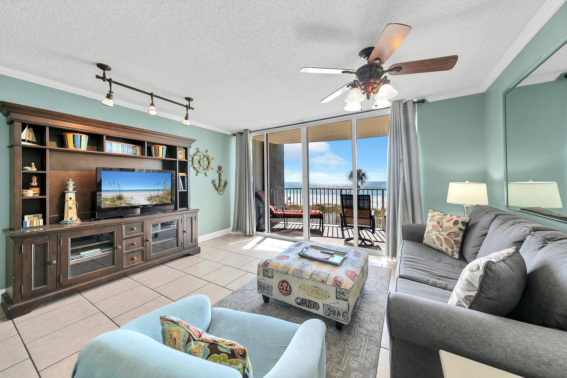 10515 Front Beach Road, Unit 102 Panama City Beach, FL 32407 - Photo 8 of 19 a living room with furniture and a flat screen tv