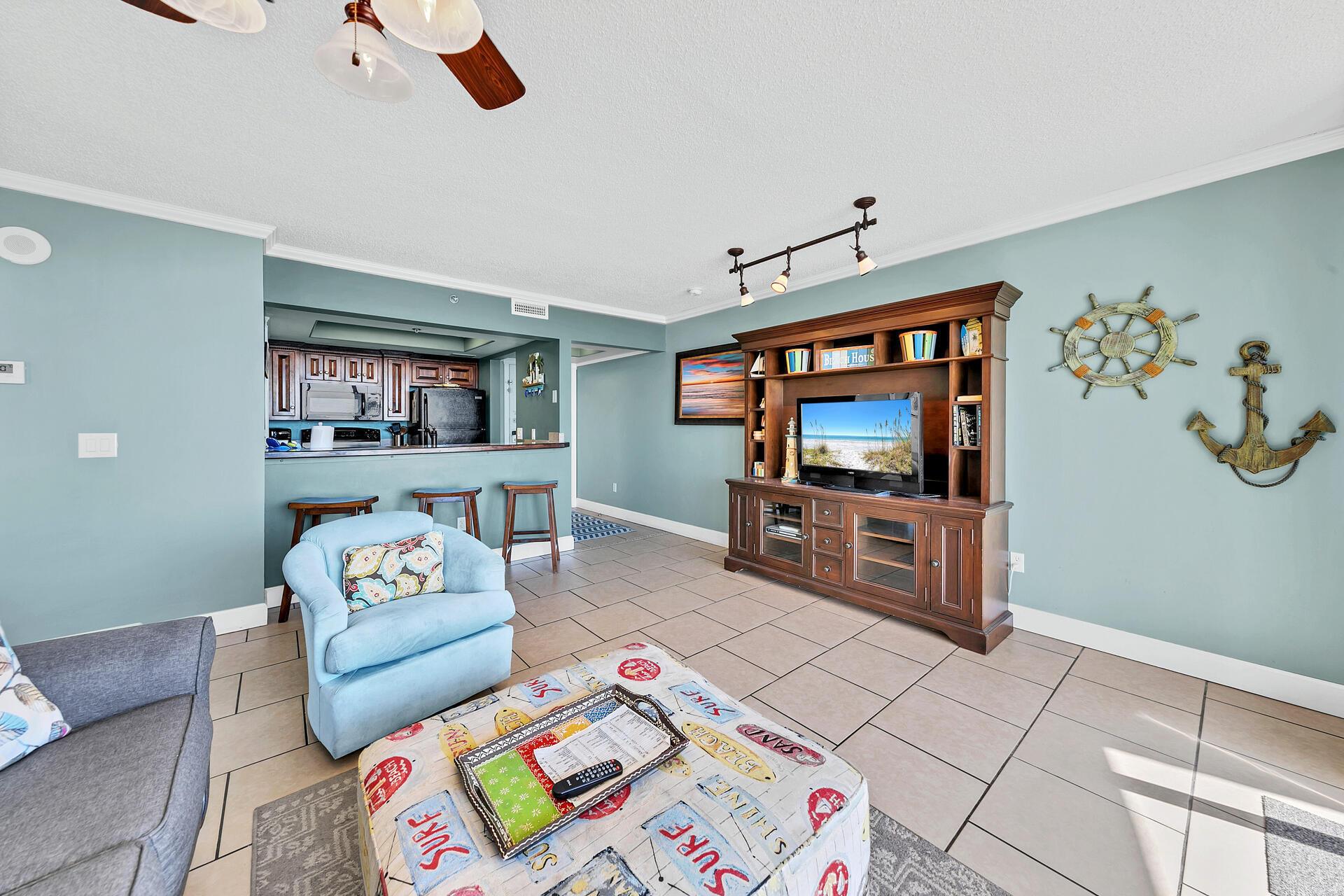 10515 Front Beach Road, Unit 102 Panama City Beach, FL 32407 - Photo 9 of 19 a living room with furniture and a flat screen tv
