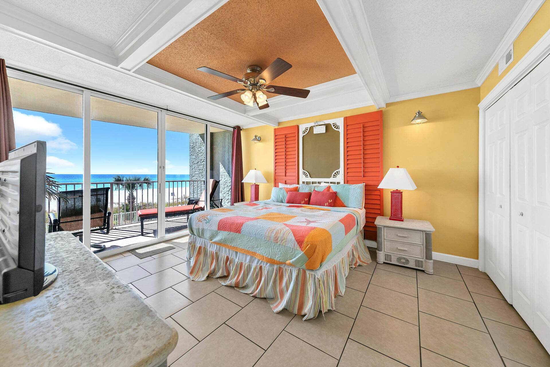 10515 Front Beach Road, Unit 102 Panama City Beach, FL 32407 - Photo 10 of 19 a spacious bedroom with a bed a table and chairs