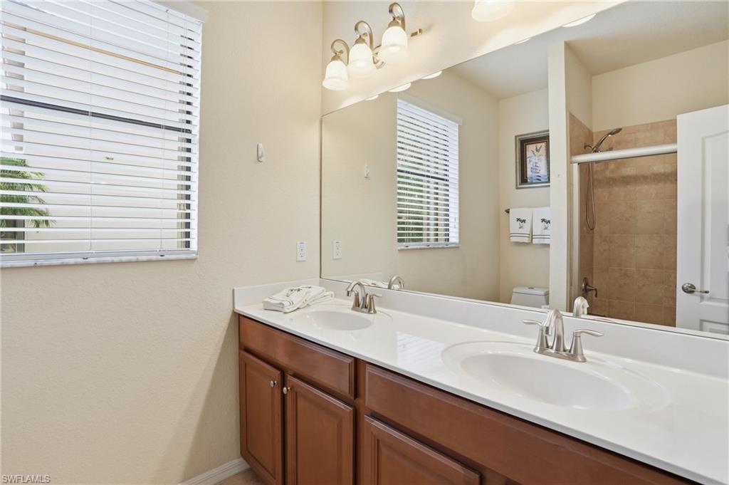 3915 Treasure Cove Circle Naples, FL 34114 - Photo 15 of 24 Full bath featuring double vanity and a stall shower