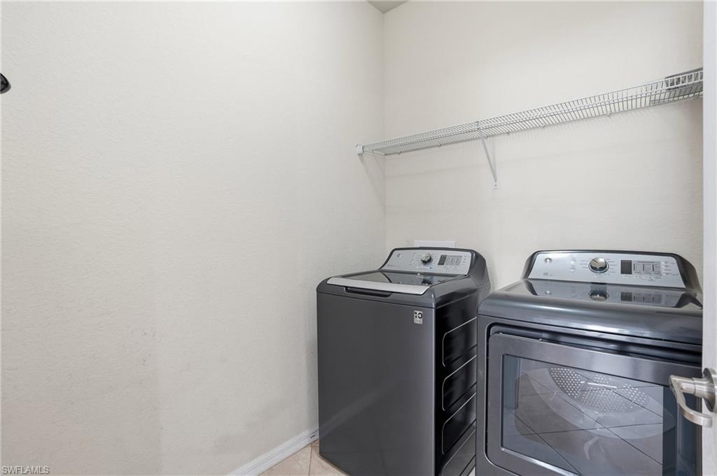 3915 Treasure Cove Circle Naples, FL 34114 - Photo 19 of 24 Washroom featuring independent washer and dryer and baseboards