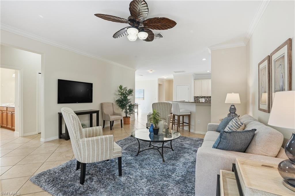 3915 Treasure Cove Circle Naples, FL 34114 - Photo 6 of 24 Living area with ornamental molding, light tile patterned flooring, ceiling fan, and recessed lighting