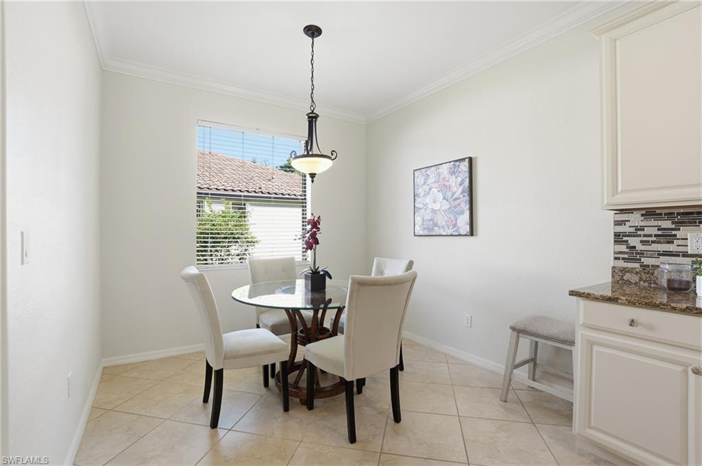 3915 Treasure Cove Circle Naples, FL 34114 - Photo 9 of 24 Dining area with ornamental molding and light tile patterned floors