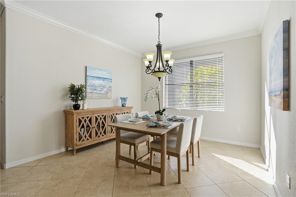 3915 Treasure Cove Circle Naples, FL 34114 - Photo 10 of 24 Dining space with a chandelier, ornamental molding, and light tile patterned floors