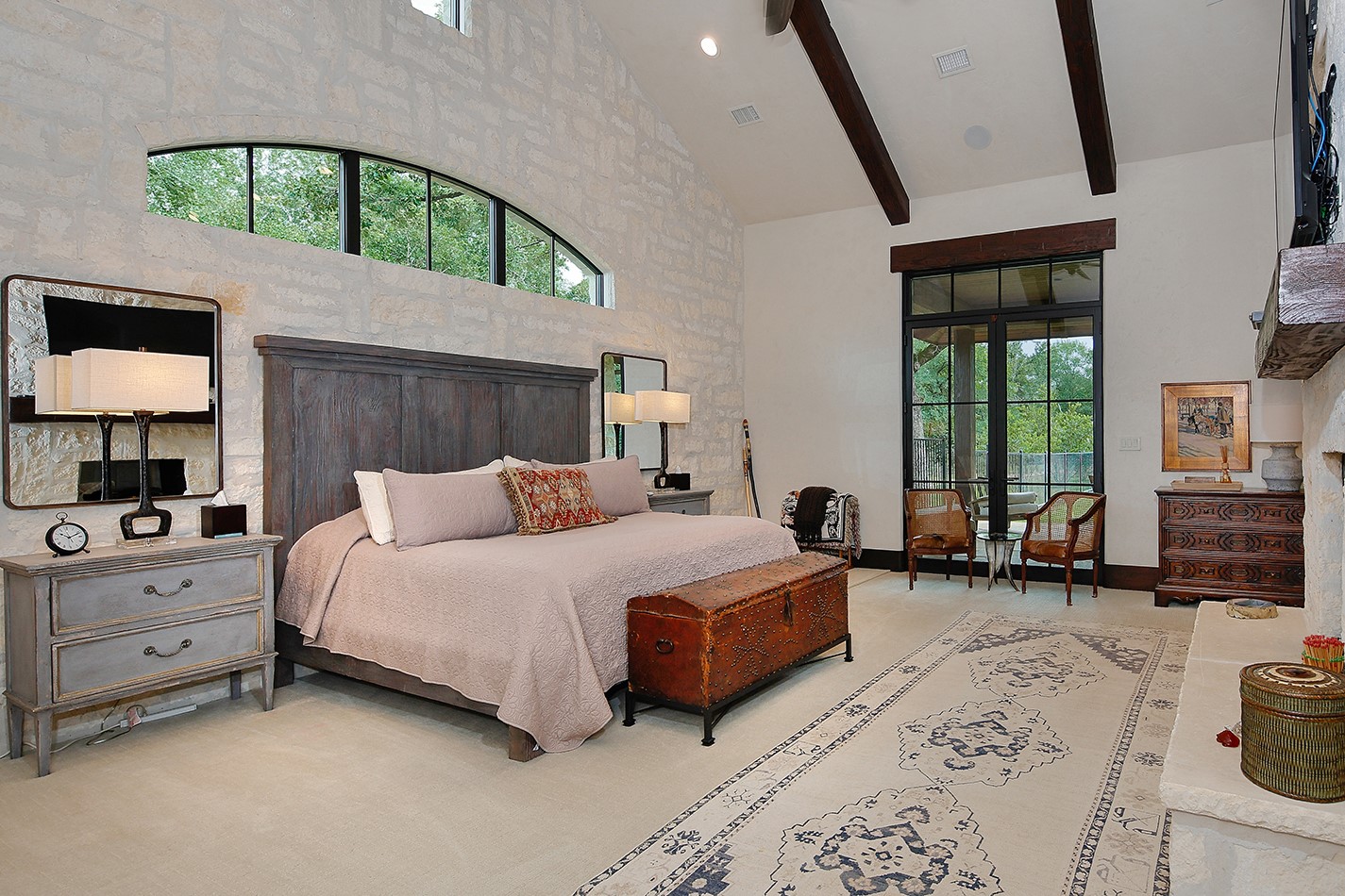 40693 Center Hill Road Hempstead, TX 77445 - Photo 12 of 50 Unwind in this spectacular bedroom with plush carpeting, a stone double sided gas log fireplace, stone wall, vaulted ceiling, exposed beams and access to a private patio with yet another fireplace.