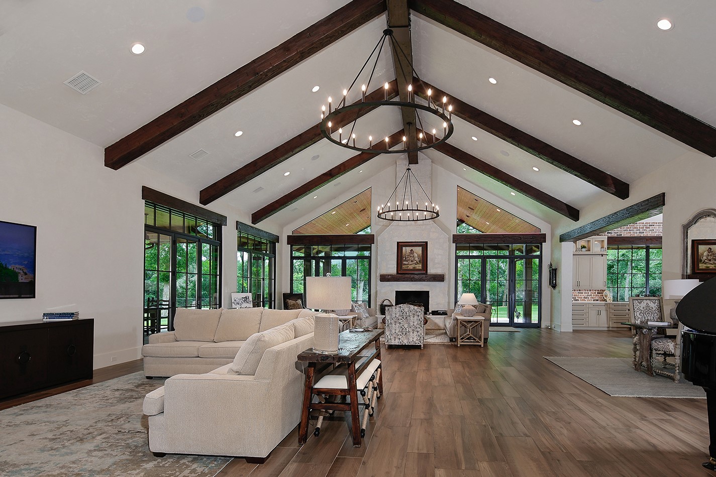 40693 Center Hill Road Hempstead, TX 77445 - Photo 19 of 50 The open concept welcomes family and friends into this impressive room. With a 20 foot ceiling, exposed wood beams and anchored by a stone two story remote controlled fireplace. The French doors open to a sprawling wrap around back patio area extending your entertaining space.