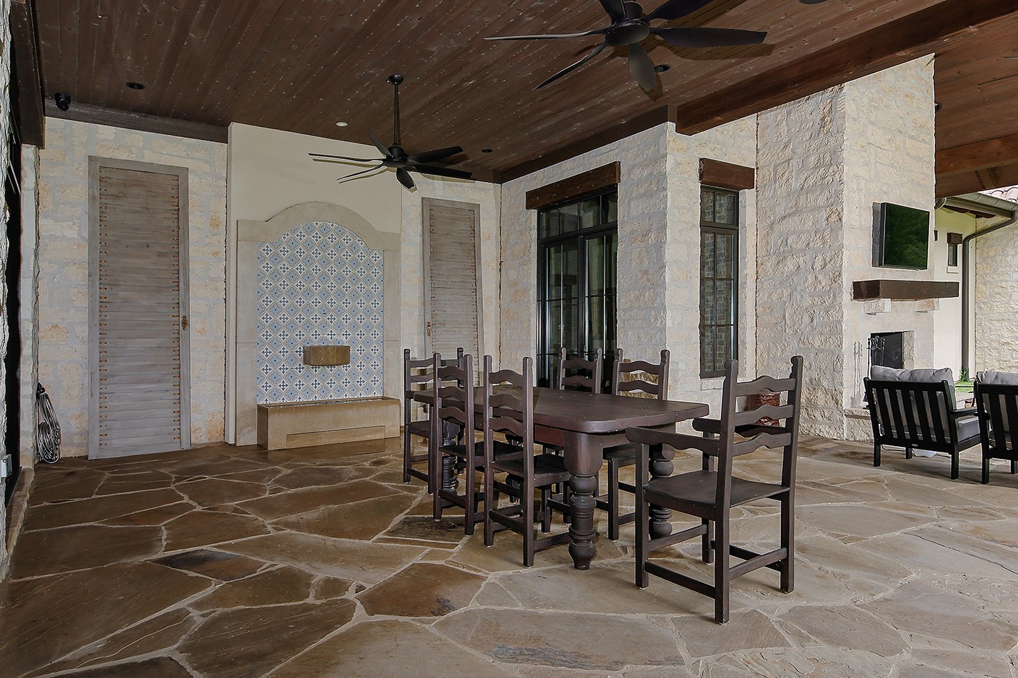 40693 Center Hill Road Hempstead, TX 77445 - Photo 35 of 50 Part of the expansive covered patio area with flagstone decking, a water feature and outdoor wood burning fireplace.