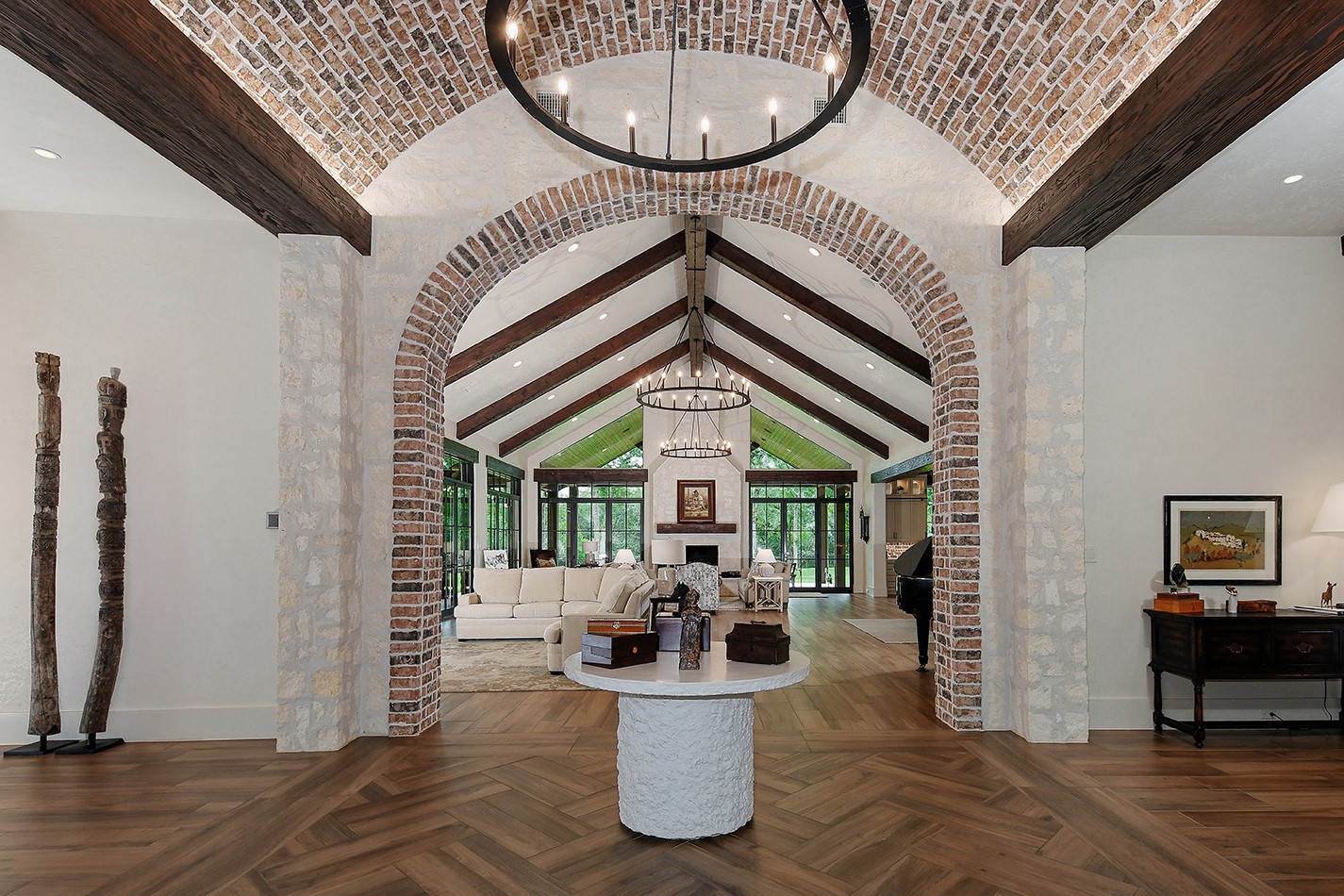 40693 Center Hill Road Hempstead, TX 77445 - Photo 5 of 50 The grand entry with stone walls, solid wood beams, barrel ceiling and herringbone detail flooring sets the tone for this incredible home.