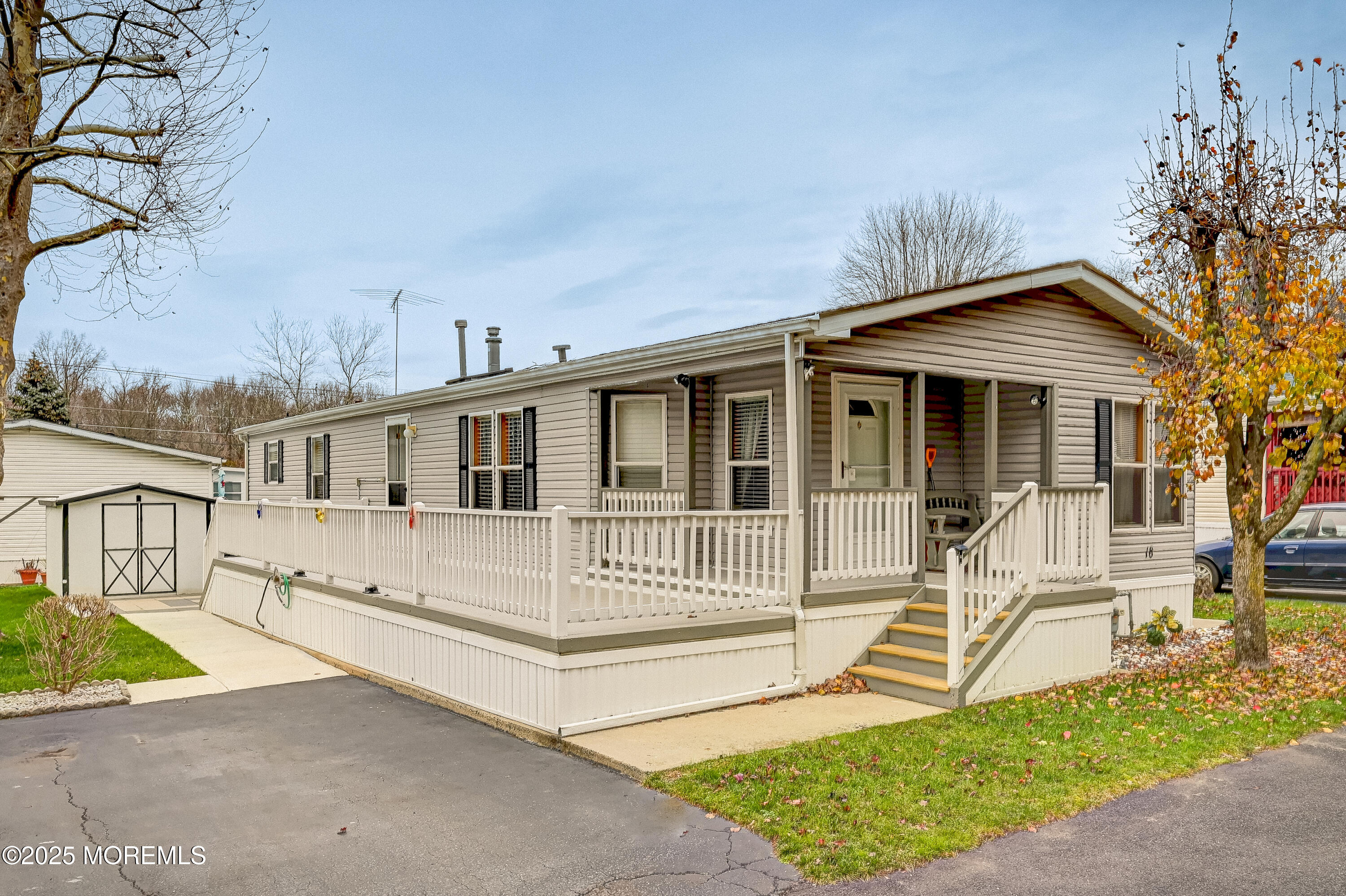 a front view of a house with a yard outdoor seating and barbeque oven