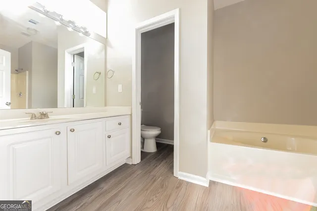 a bathroom with a sink a toilet and a bathtub