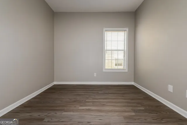 a view of a room with wooden floor and window