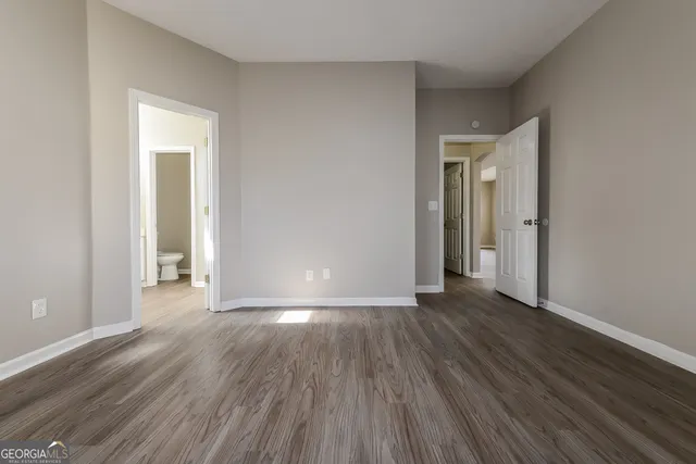a view of an empty room and wooden floor