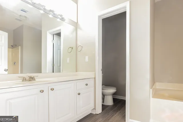 a bathroom with a double vanity sink and a mirror