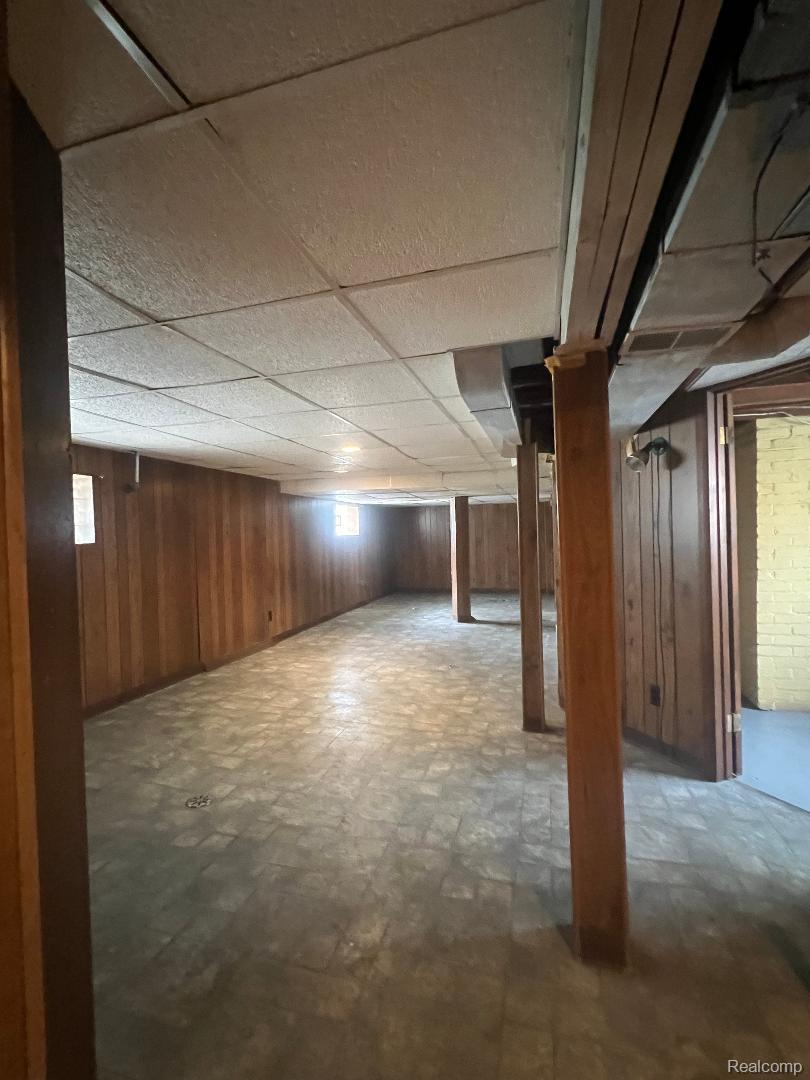 149 Roth Boulevard Clawson, MI 48017 - Photo 16 of 20 Spacious lower level featuring wood paneling, drop ceiling, and exposed support beams