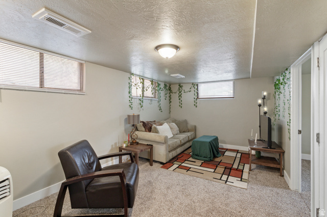 386 North 500 East Provo, UT 84606 - Photo 17 of 24 Living area with a textured ceiling and light carpet