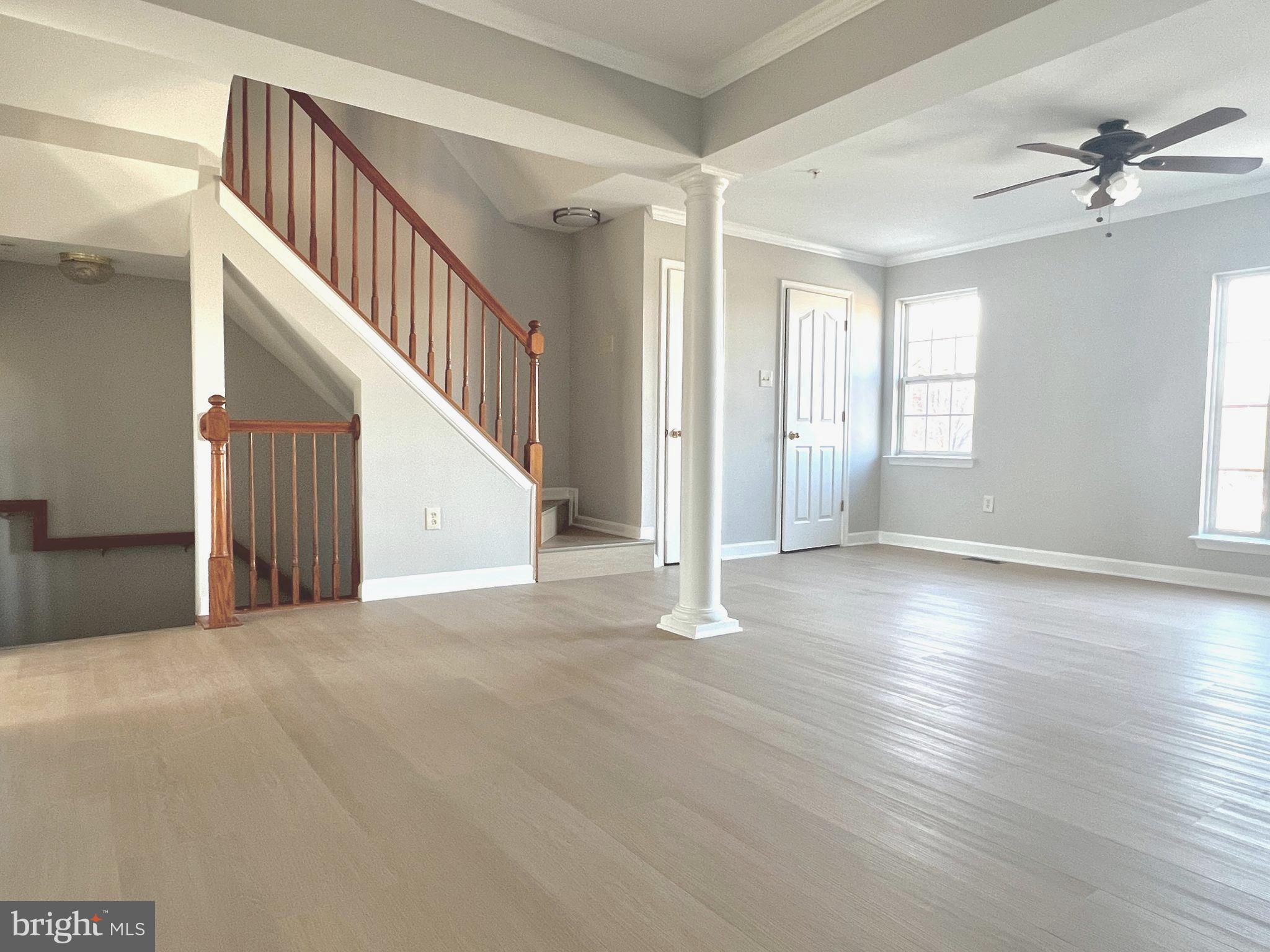 2026 Weitzel Court Frederick, MD 21702 - Photo 13 of 30 a view of an empty room with wooden floor and a ceiling fan
