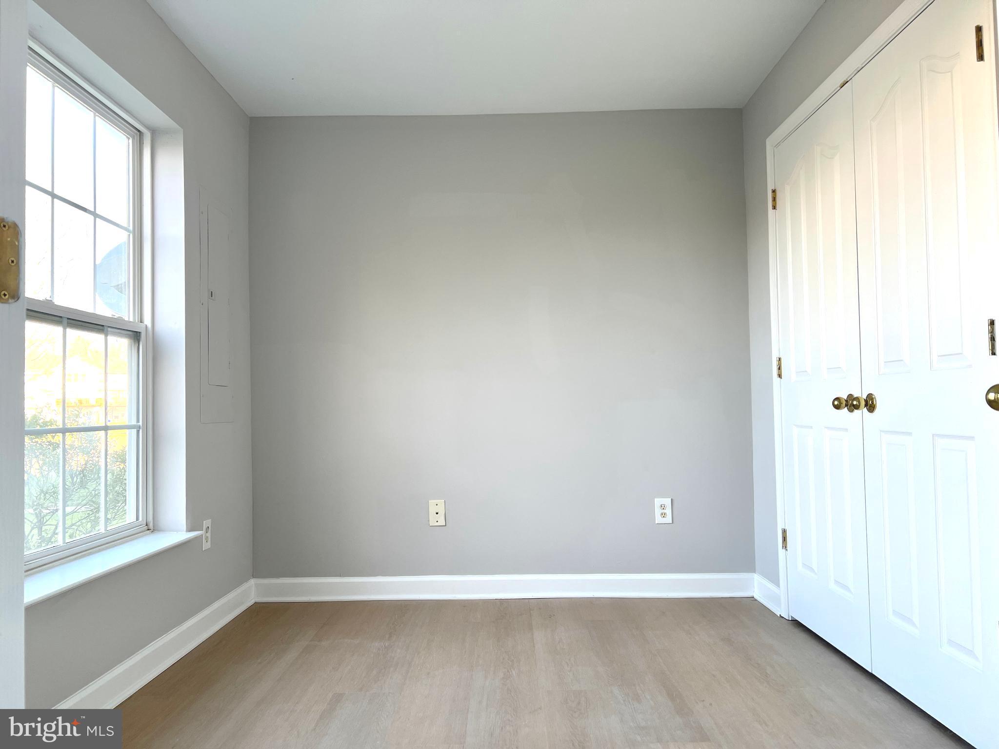 2026 Weitzel Court Frederick, MD 21702 - Photo 4 of 30 an empty room with wooden floor and windows