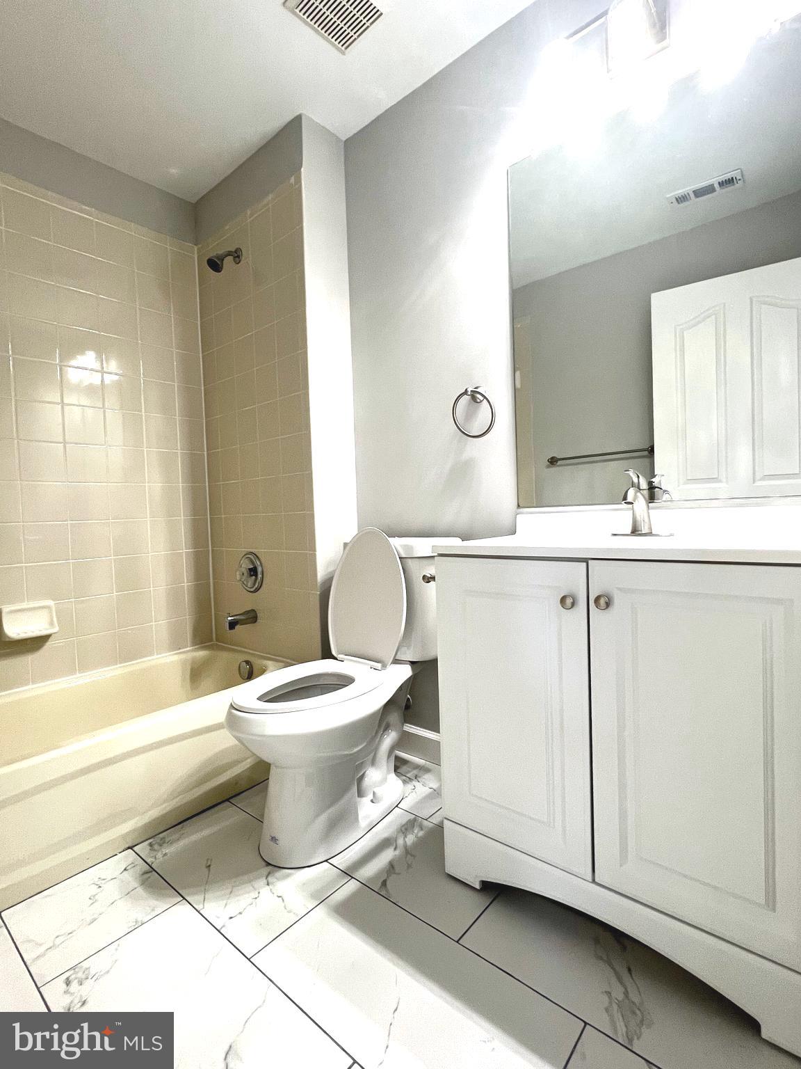 2026 Weitzel Court Frederick, MD 21702 - Photo 5 of 30 a bathroom with a toilet sink and mirror