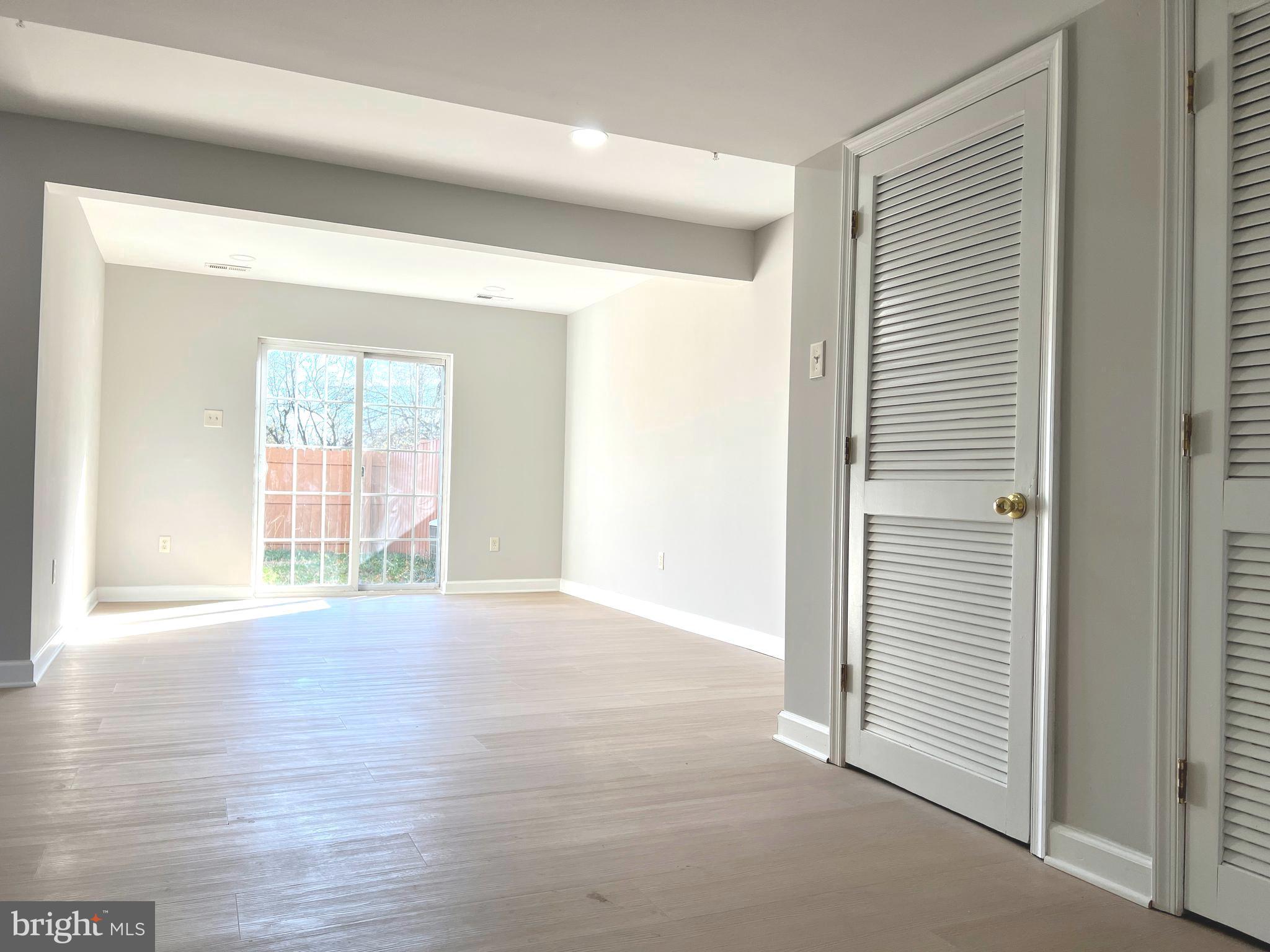 2026 Weitzel Court Frederick, MD 21702 - Photo 6 of 30 a view of an empty room with wooden floor and a window