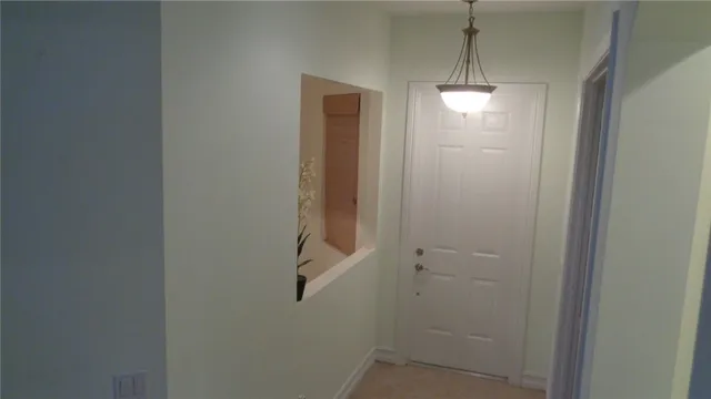 a view of hallway with wooden floor and stairs