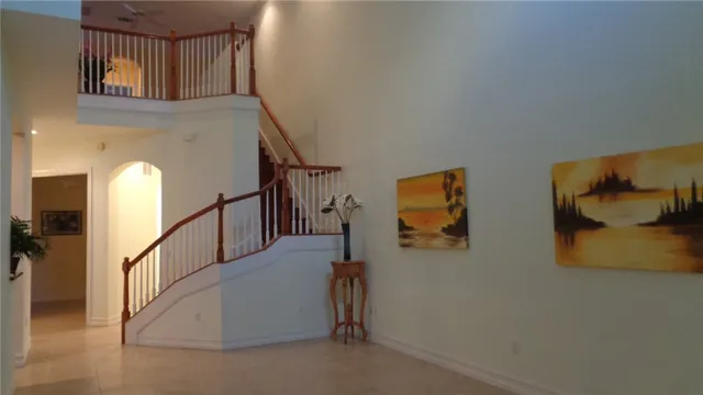 an empty room with a mirror and a hallway