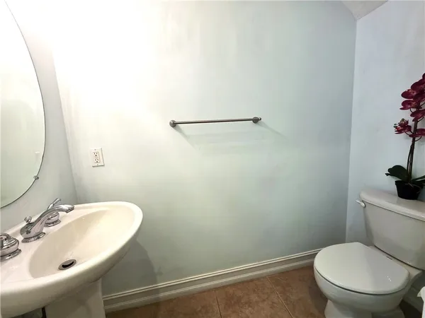 a bathroom with a sink mirror and toilet