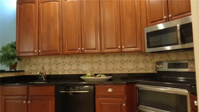 a kitchen with stainless steel appliances a stove a microwave sink and cabinets