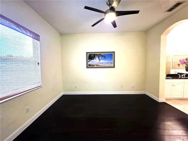 a view of a big room with wooden floor and windows