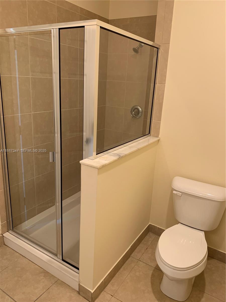 1044 Southwest 147th Avenue, Unit 10105 Pembroke Pines, FL 33027 - Photo 12 of 23 a bathroom with a toilet and a shower