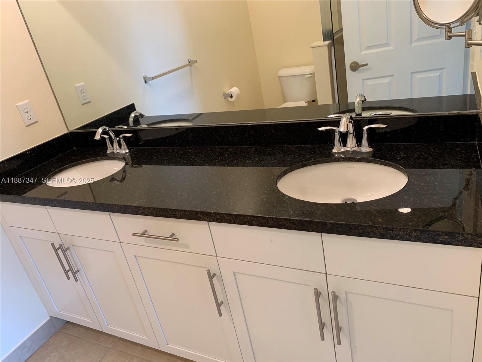 1044 Southwest 147th Avenue, Unit 10105 Pembroke Pines, FL 33027 - Photo 20 of 23 a bathroom with a sink and a mirror