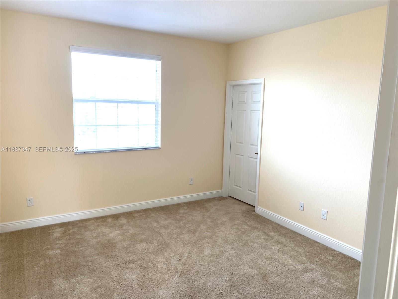 1044 Southwest 147th Avenue, Unit 10105 Pembroke Pines, FL 33027 - Photo 22 of 23 an empty room with a window
