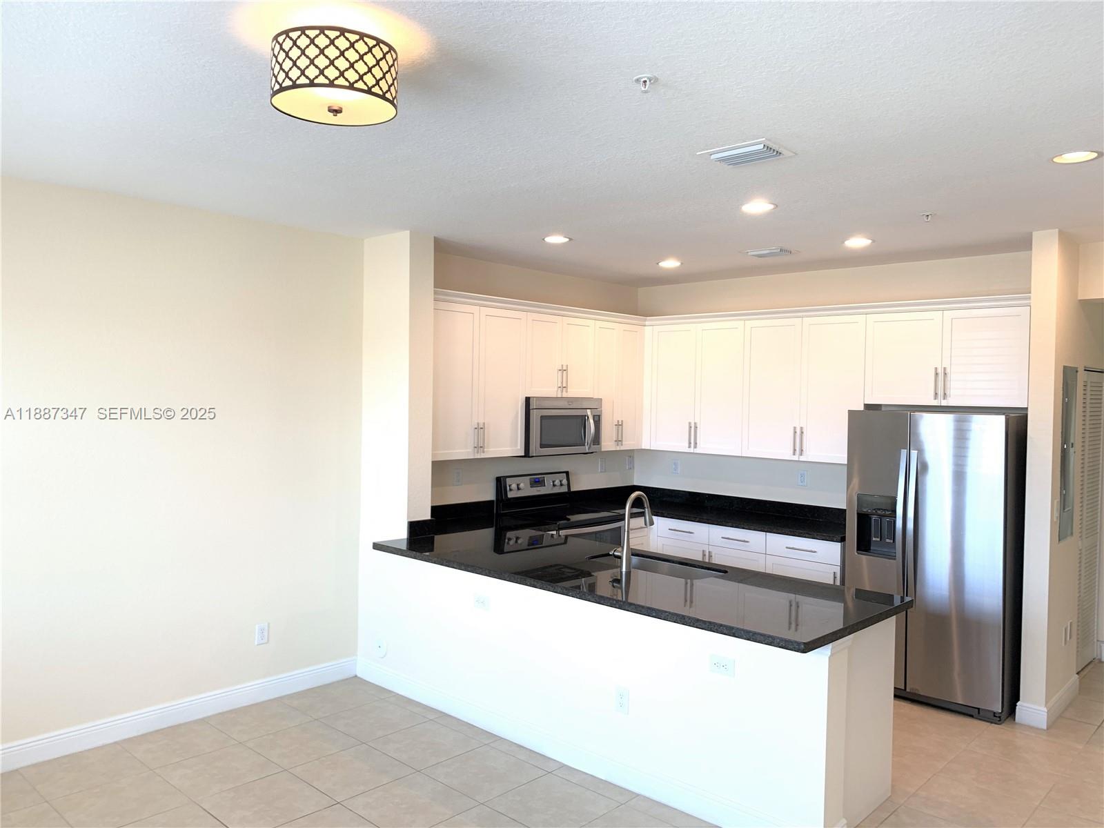 1044 Southwest 147th Avenue, Unit 10105 Pembroke Pines, FL 33027 - Photo 3 of 23 a view of a kitchen with a sink