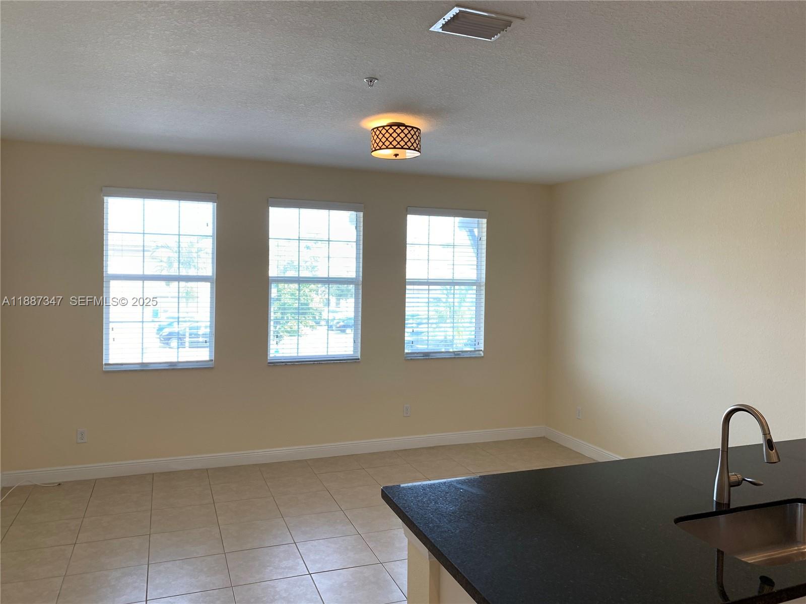 1044 Southwest 147th Avenue, Unit 10105 Pembroke Pines, FL 33027 - Photo 5 of 23 an empty room with windows