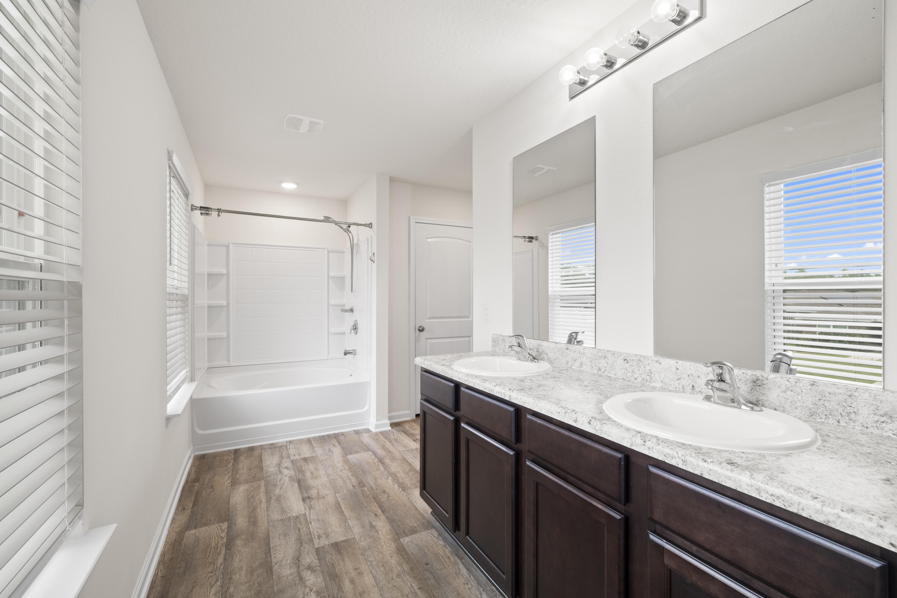 814 Moorhen Way Crestview, FL 32539 - Photo 16 of 29 a bathroom with a granite countertop sink a toilet a mirror and shower