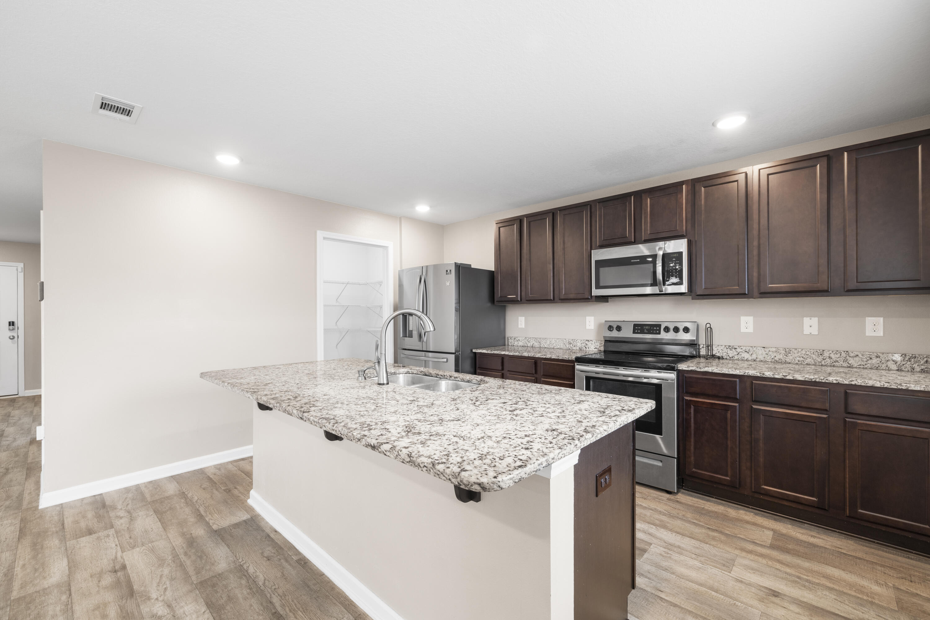 814 Moorhen Way Crestview, FL 32539 - Photo 19 of 29 a kitchen with stainless steel appliances granite countertop a sink stove microwave and refrigerator