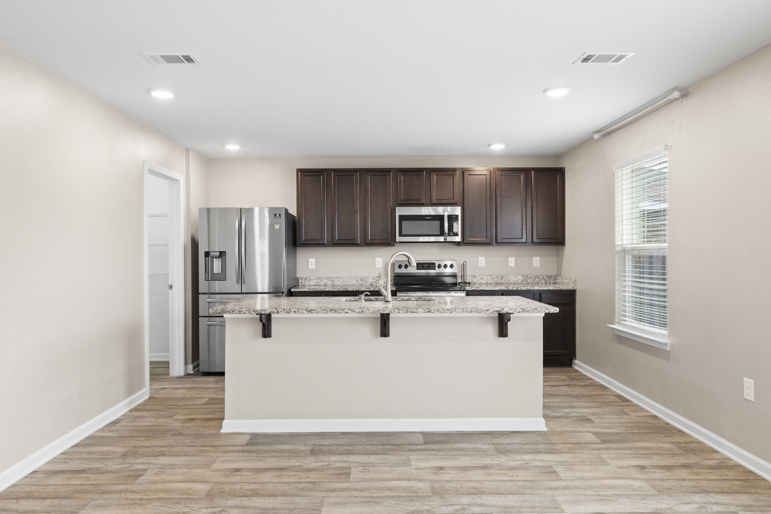 814 Moorhen Way Crestview, FL 32539 - Photo 22 of 29 a kitchen with a refrigerator a stove top oven and kitchen island