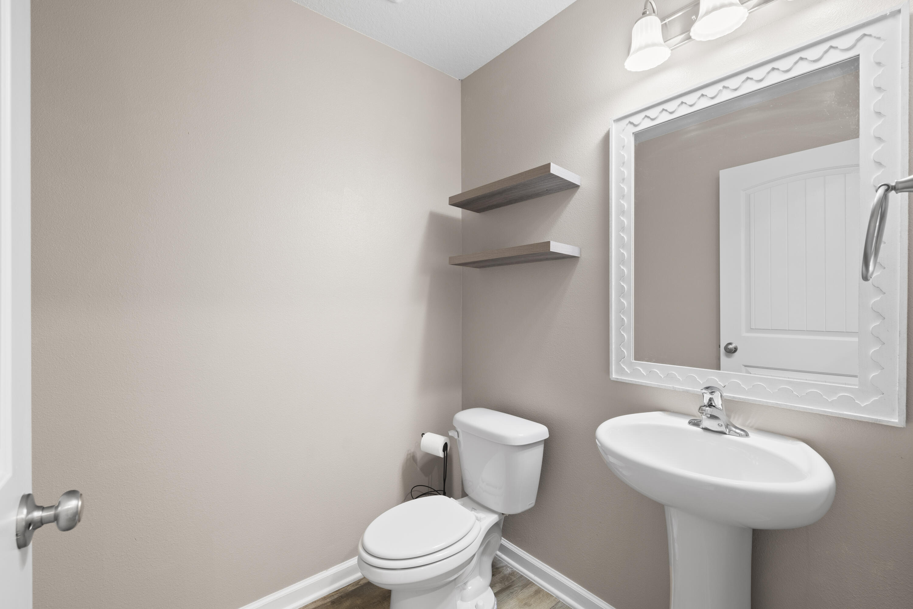 814 Moorhen Way Crestview, FL 32539 - Photo 24 of 29 a bathroom with a toilet sink and mirror