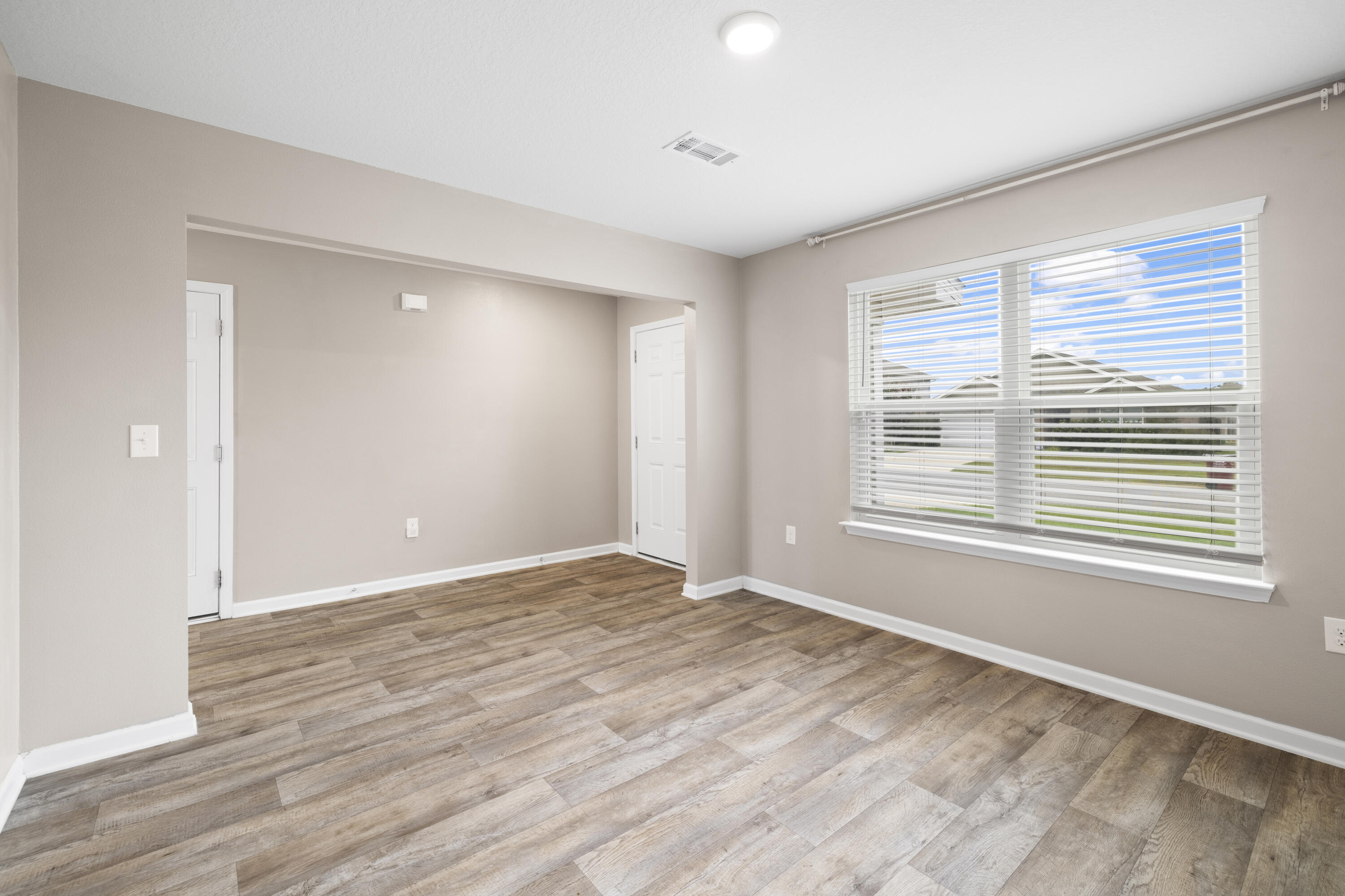 814 Moorhen Way Crestview, FL 32539 - Photo 25 of 29 a view of an empty room with wooden floor and a window