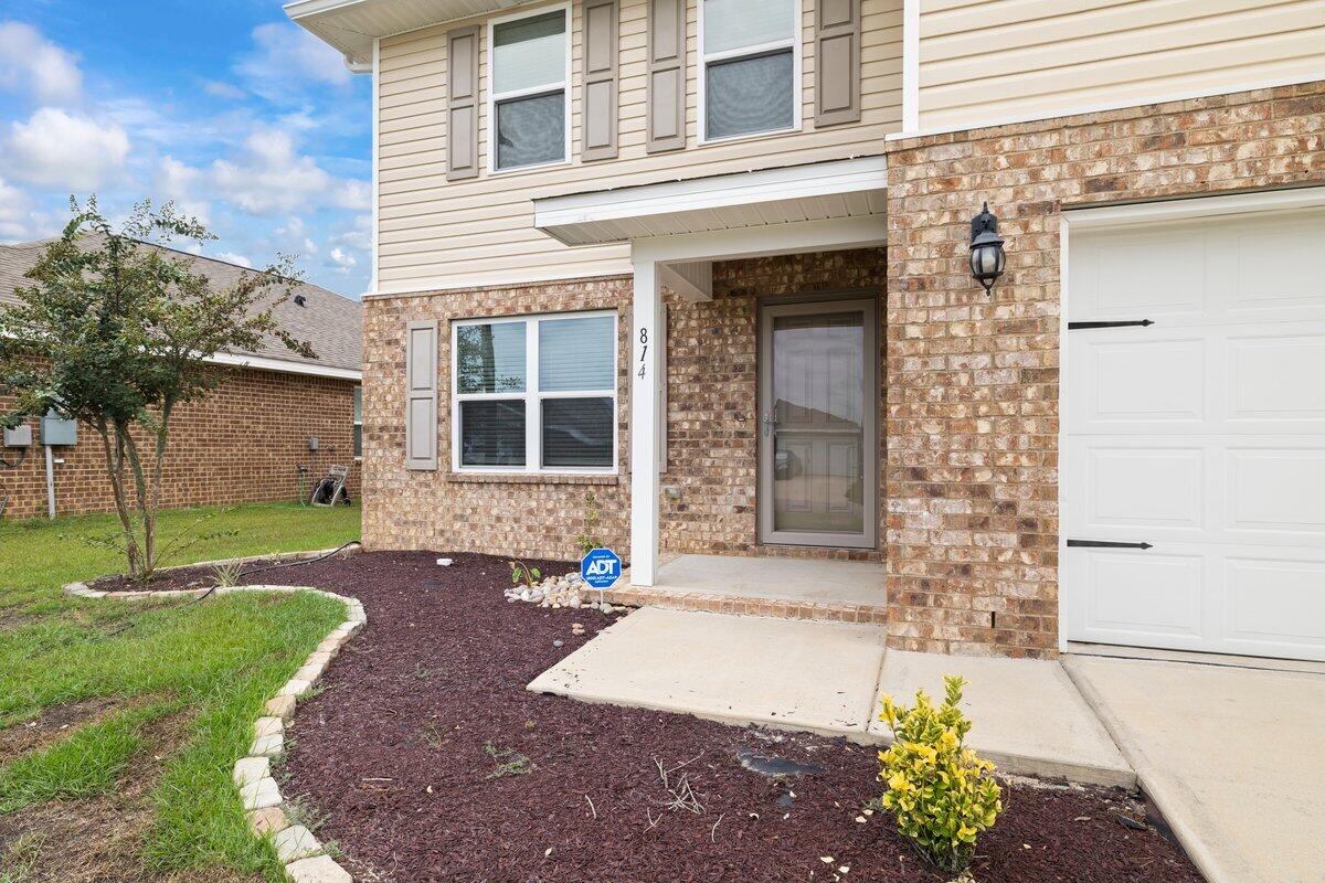 814 Moorhen Way Crestview, FL 32539 - Photo 27 of 29 a front view of a house with a garden and yard