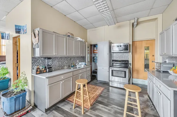a kitchen with stainless steel appliances a stove a sink and a refrigerator